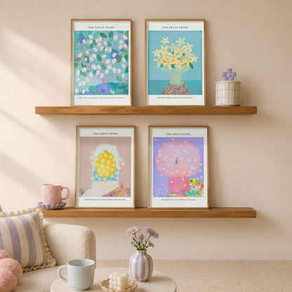 Four posters of The Fruit Story Collection are displayed on two wooden floating shelves in a cozy, sunlit living room setting with a sofa, pillows, and small decorative vases.