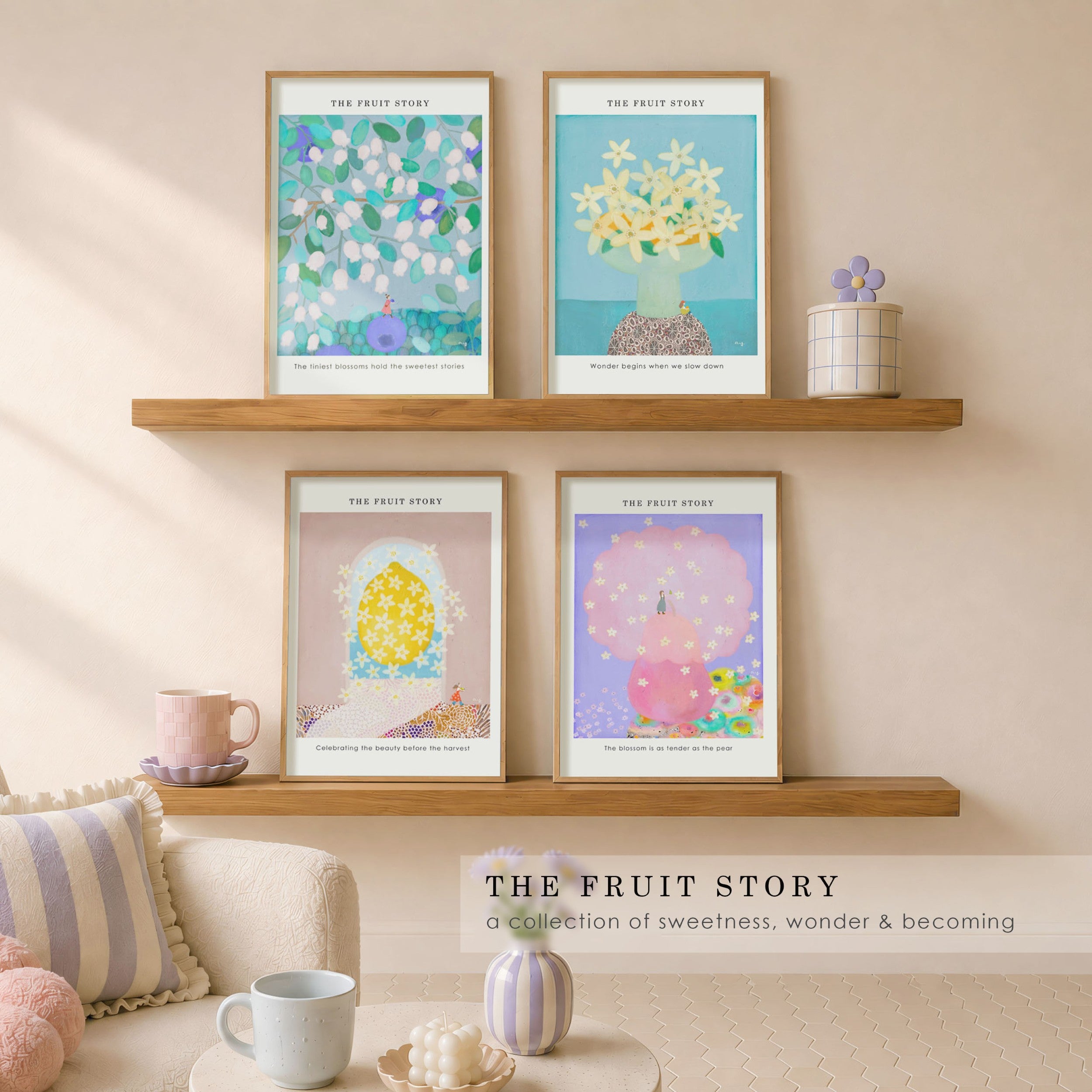 Four framed art prints titled 'THE FRUIT STORY' displayed on two wooden floating shelves in a cozy, sunlit living room setting. The prints feature whimsical, colorful illustrations of fruit flower blossoms.