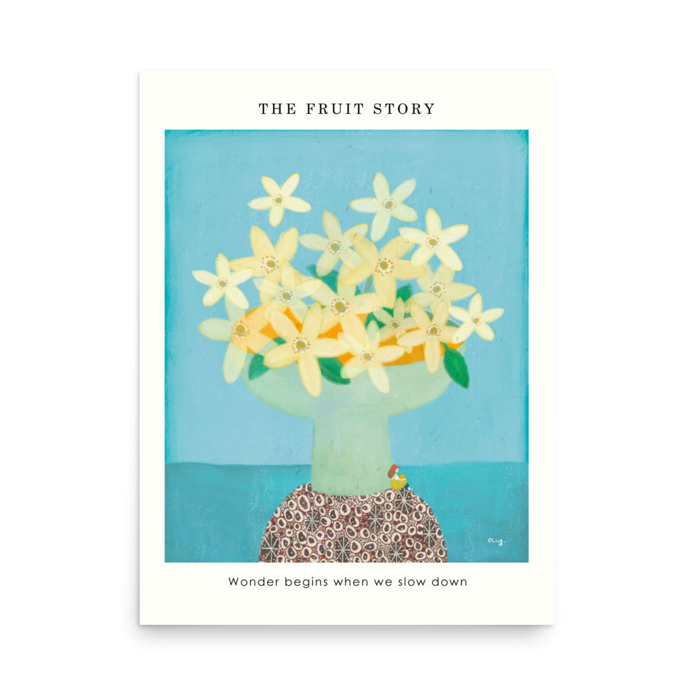 Orange Poster from The Fruit Story showing pale yellow orange blossoms in a light green vase on a patterned table, with the printed message “Wonder begins when we slow down.”