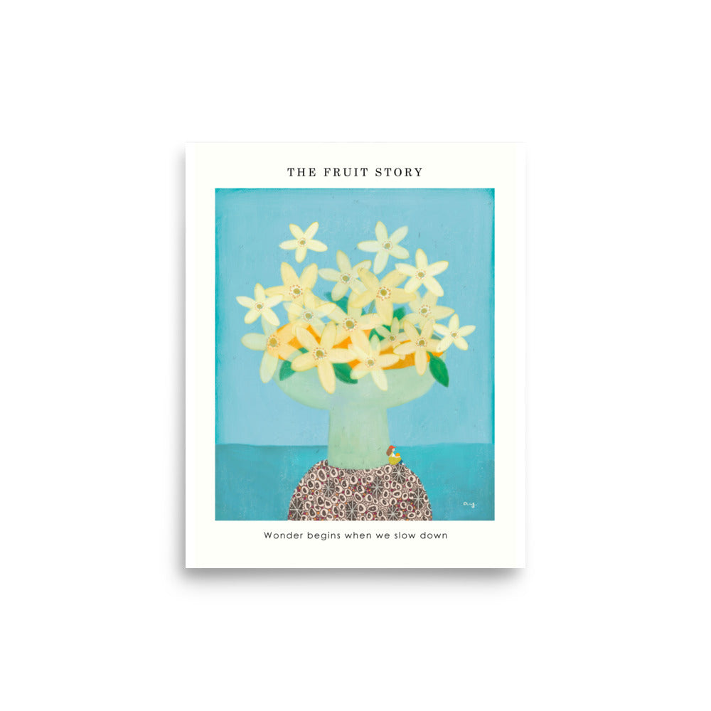 Orange Poster from The Fruit Story showing pale yellow orange blossoms in a light green vase on a patterned table, with the printed message “Wonder begins when we slow down.”