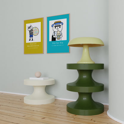 Sip by Sip – cozy cat illustration from the Malo Collection, shown as wall art displayed in a living room